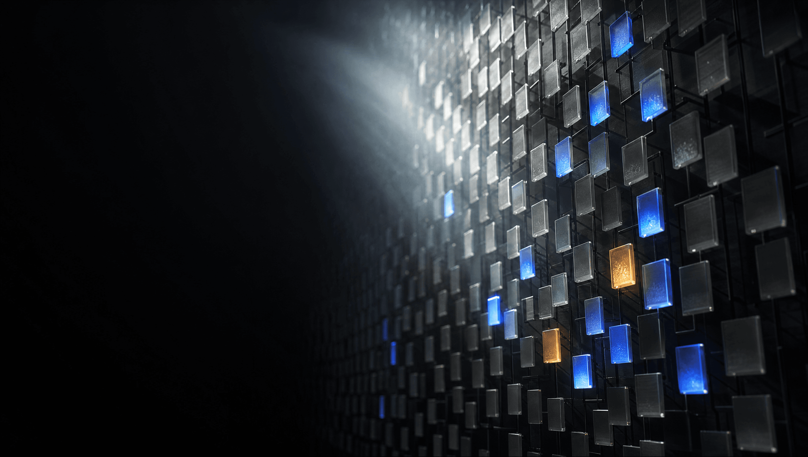 A dark wall of tiles with a sparse few glowing blue and amber: sparse attention keeping a handful of blocks and ignoring the rest.